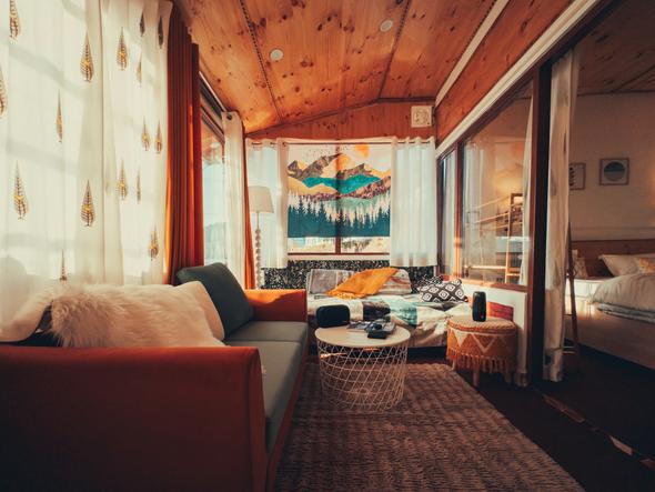 This image showcases a professionally staged and well-maintained vacation rental. It highlights the high-quality property presentation that an experienced co-host helps owners maintain. This includes keeping the living space pristine, cozy, and perfectly styled to secure 5-star reviews and increase booking rates.