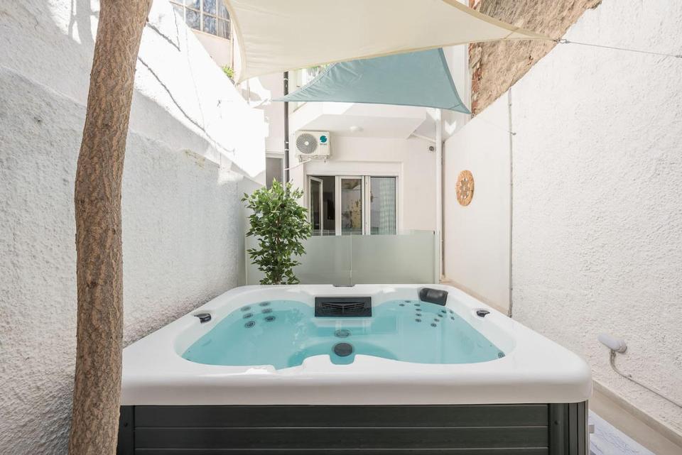 Hostaway customer WelcomeHost is Athens' leading short term and vacation rental company. This image shows an outdoor hot tub at one of their properties. Learn why they made the switch from Guesty to Hostaway.