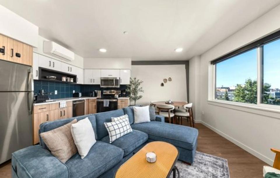 A living room and pantry going with the color schemes of white, blue, and brown.