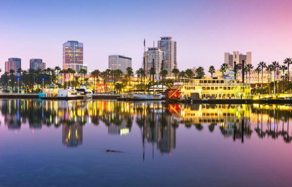 The iconic skyline of Long Beach, boasting luxury yachts in the sea.