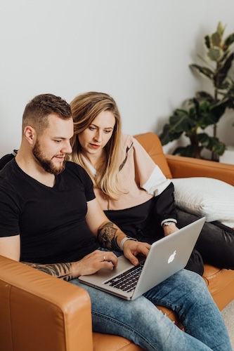 Marketing professional creating personalized discount coupons and promotional codes for vacation rental bookings with targeted date ranges and social media campaign integration